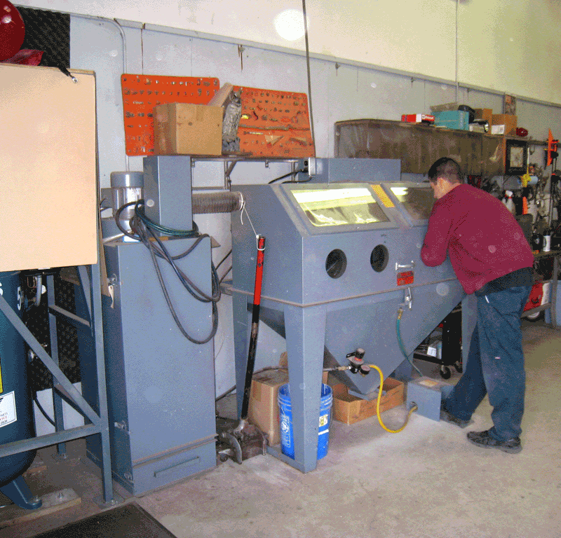 Bead-blast cabinet and metalwork bench in the Shelby Trim machine shop.