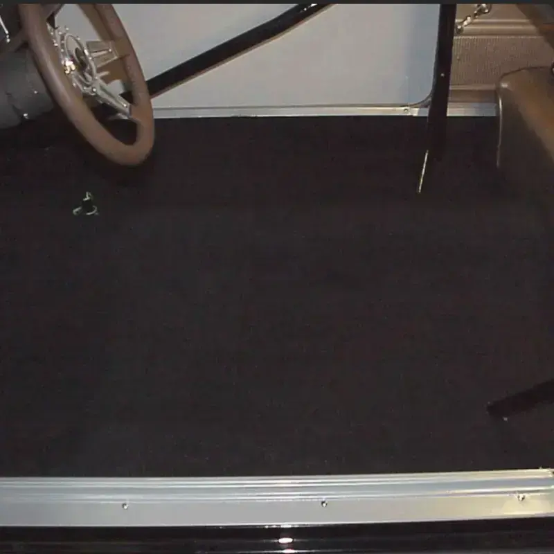Black automotive carpet installation by Shelby Trim.