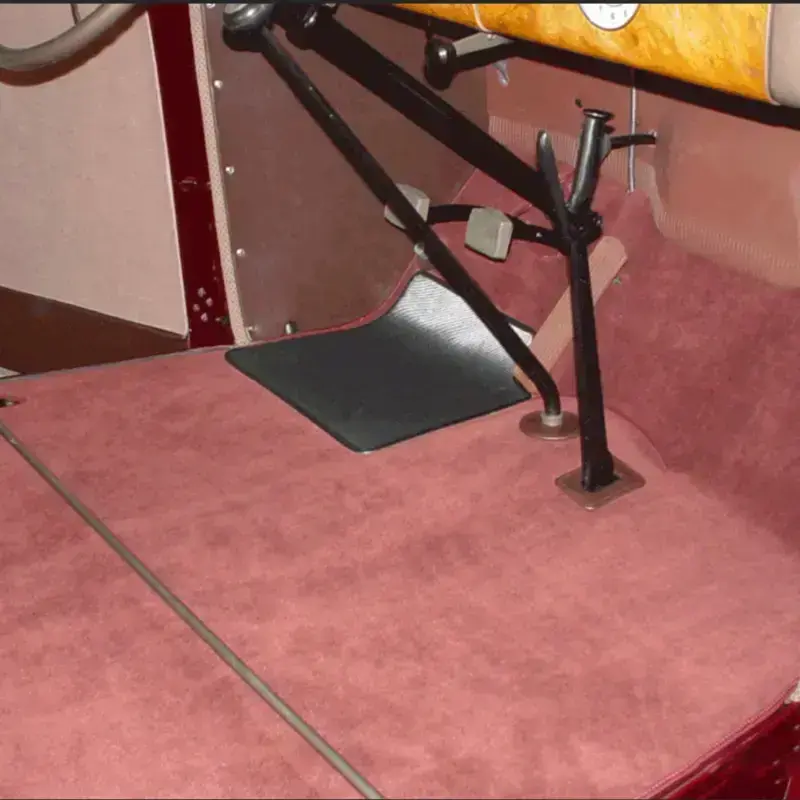 Red automotive carpet installation by Shelby Trim.