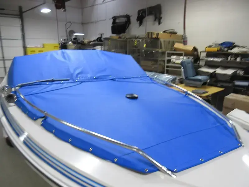 Blue cockpit cover on a boat - front view.