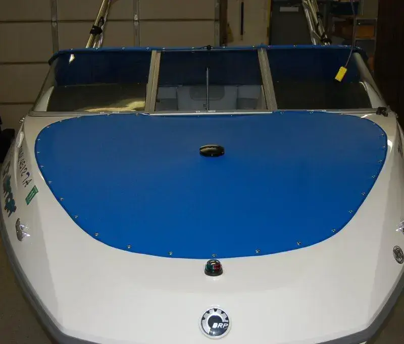 Blue marine canvas front cover on a trailerable boat.