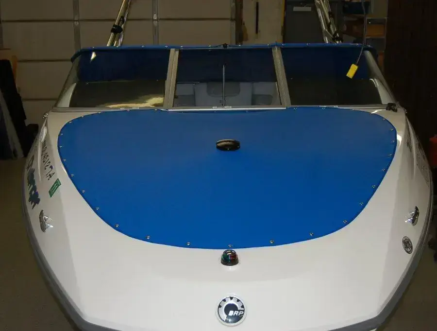 Blue marine canvas front cover on a trailerable boat.
