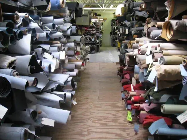 Rolls of automotive cloth, vinyl, and leather stocked at the Shelby Trim showroom.
