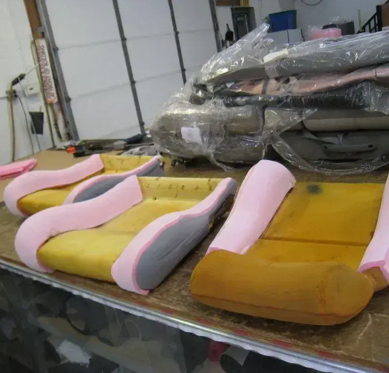 Hand-shaped seat foam being prepared for upholstery.