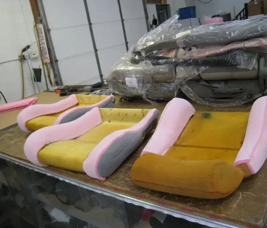 Hand-shaped seat foam being prepared for upholstery.