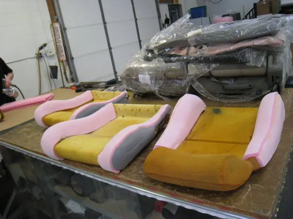 Hand-shaped seat foam being prepared for upholstery.