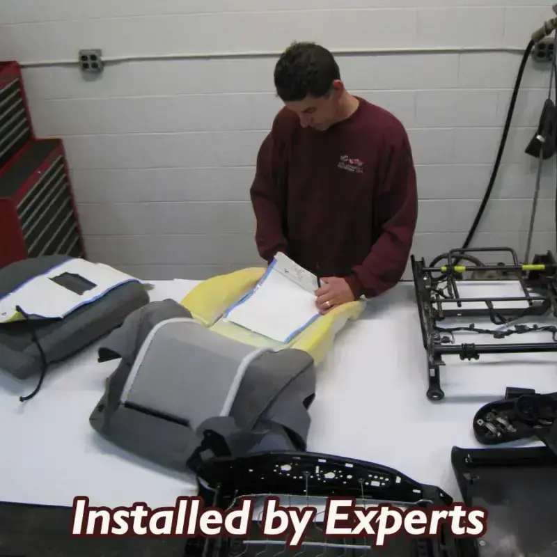 Seat heater elements being installed by a Shelby Trim technician.