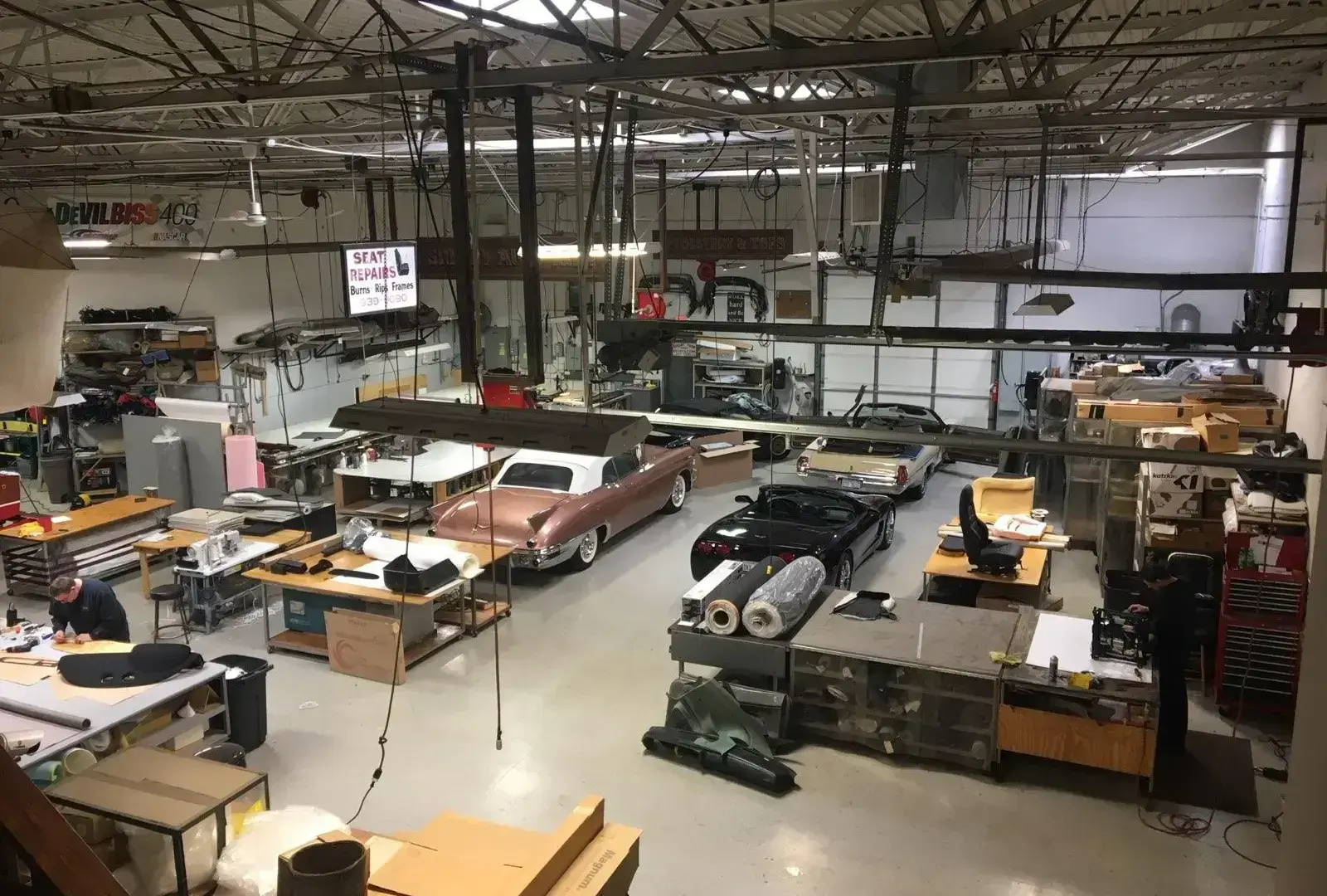 Main shop floor at Shelby Trim with vehicles in for service.