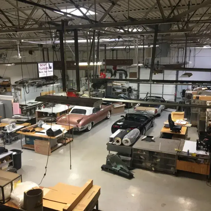 Main shop floor at Shelby Trim with vehicles in for service.