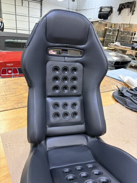 Finished performance seat recovered in black leather in the Shelby Trim shop.