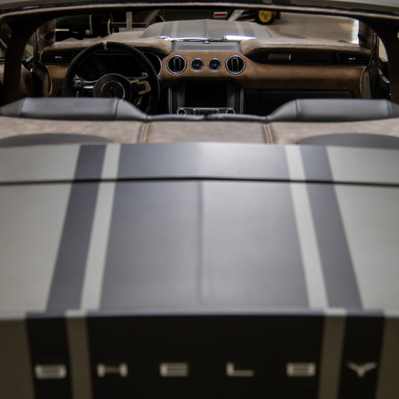 View over the rear deck of a Shelby convertible into a custom interior with a leather and suede dashboard.