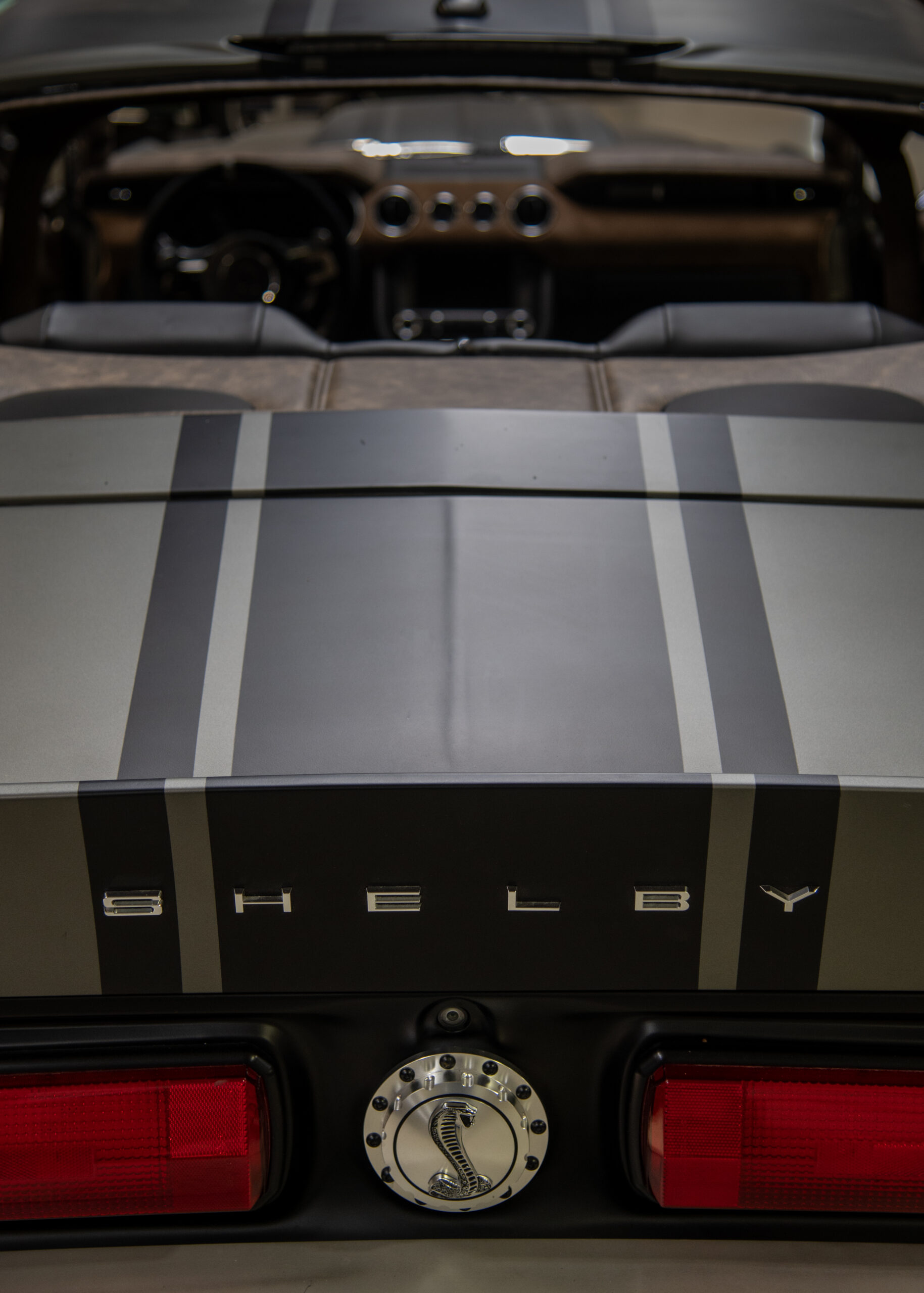 Rear of a Shelby convertible with its custom brown leather interior visible behind the rear deck.